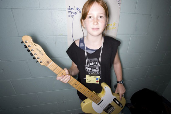 Girl with guitar at rock camp