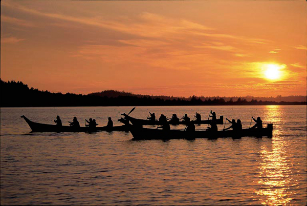 Native canoes at sunset