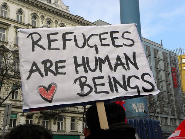 "Refugees are human beings" sign