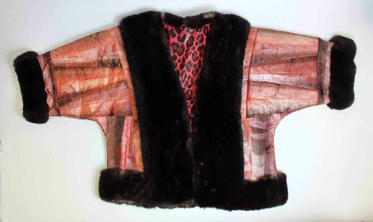 A coat made of red and silver salmon skins, trimmed with dark brown sea otter fur, with a red and black leopard skin lining.