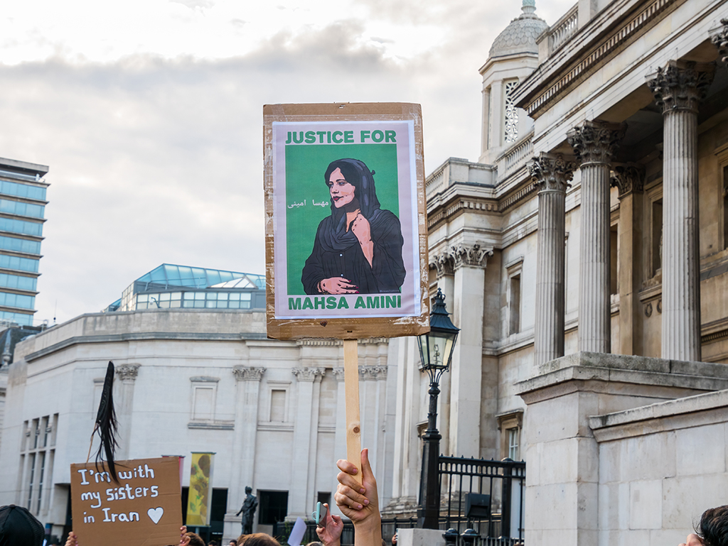 A young woman holds up a sign placard at a protest in Trafalgar Square, London, UK on Sept. 24, 2022. It reads ‘Justice for Mahsa Amini.’ Mahsa Zhina Amini was a 22-year-old Kurdish Iranian woman who died in the custody of Iranian police last month.