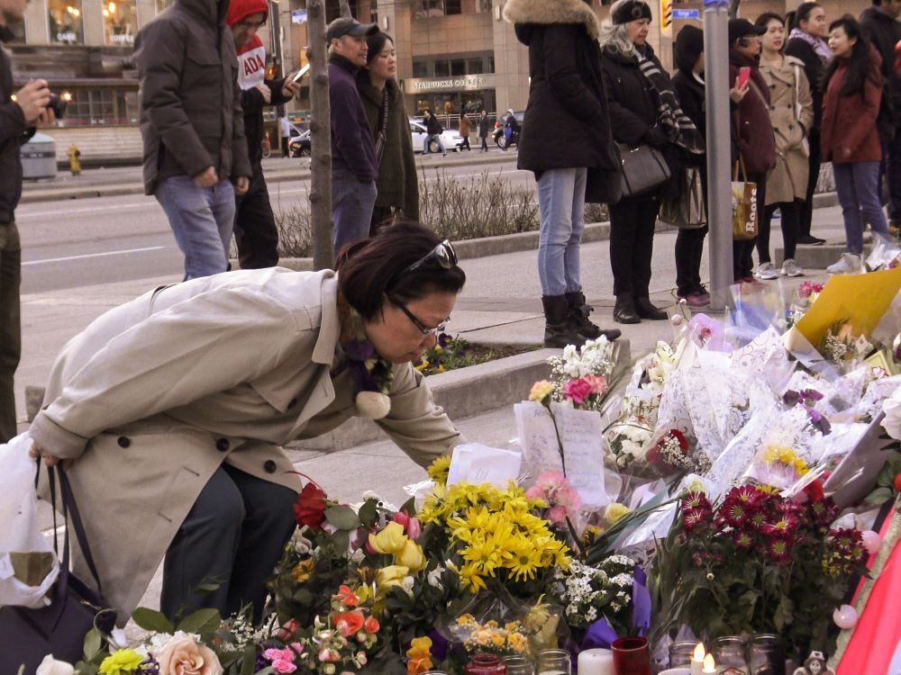 A memorial tribute of flowers, messages and candles to the victims of the tragic event from van attack on Yonge and Finch Avenue on April 23, 2018.