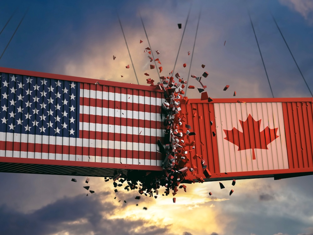 An illustration shows two shipping containers swinging from cranes, smashing into each other. One is painted with the U.S. flag, the other with the Canadian flag.