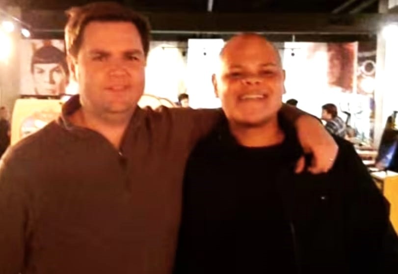 JD Vance, a light-skinned man with brown hair, with his arm around Jamil Jivani, a bald man with medium-light skin tone.
