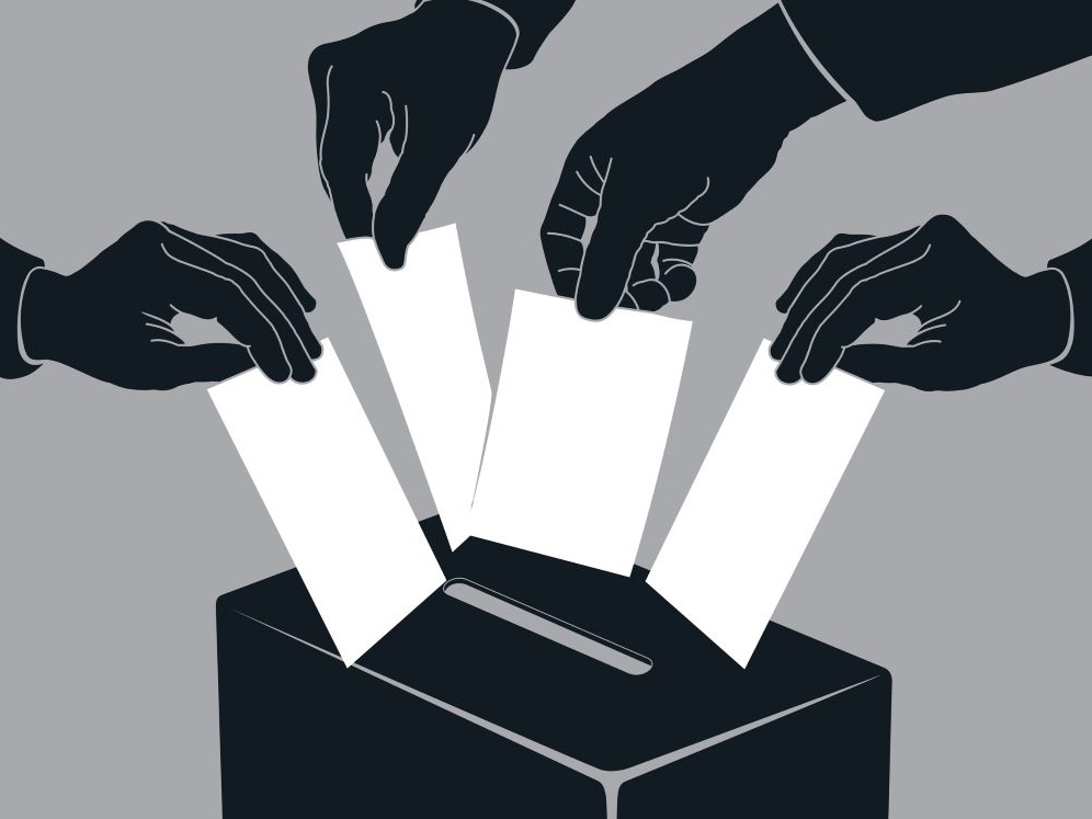 A black and white illustration shows four hands placing four ballots into a slot in a box.