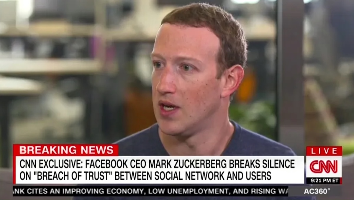 An image of Mark Zuckerberg, a fair-skinned man in his 30s, speaking on CNN. A news chyron says, &lsquo;Facebook CEO Mark Zuckerberg Breaks Silence on &lsquo;Breach of Trust&rsquo; Between Social Network and Users.&rsquo;