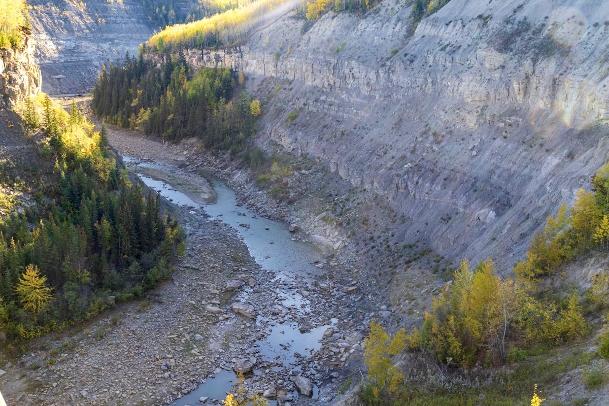 A river bed in a curving gulch is visible, with the river itself having largely dried up.