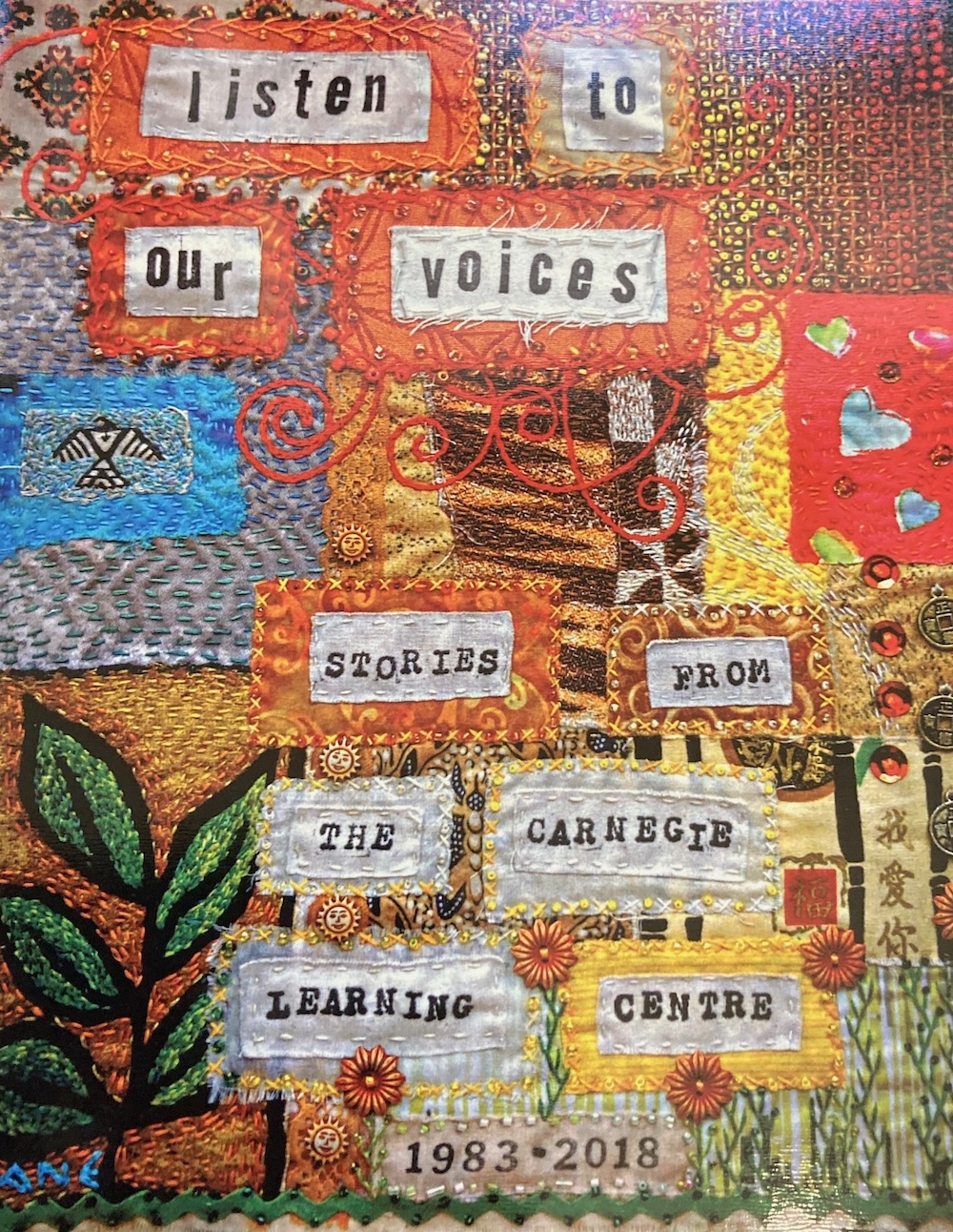 A colourful patchwork quilt reads, &lsquo;Listen to our voices. Stories from the Carnegie Learning Centre, 1983-2018.&rsquo;