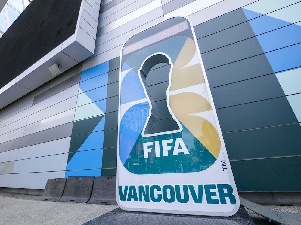 A colourful smartphone-shaped timepiece with a red digital countdown clock at its top features a FIFA trophy-shaped cutout in the centre for a person to pose inside for photos.