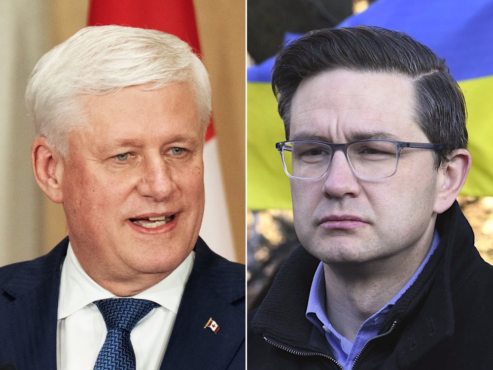 On the left is Stephen Harper, a man with white hair wearing a navy suit and tie. On the right is Pierre Poilievre, a man with dark hair and glasses wearing a black zip-up sweater over a lilac-coloured shirt.