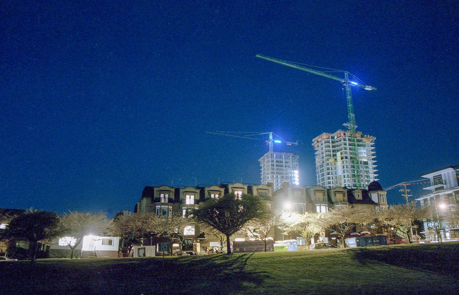 A house on the left, mid-rises in the middle, towers on the right. It’s night, and the developments look like an ascending graph.