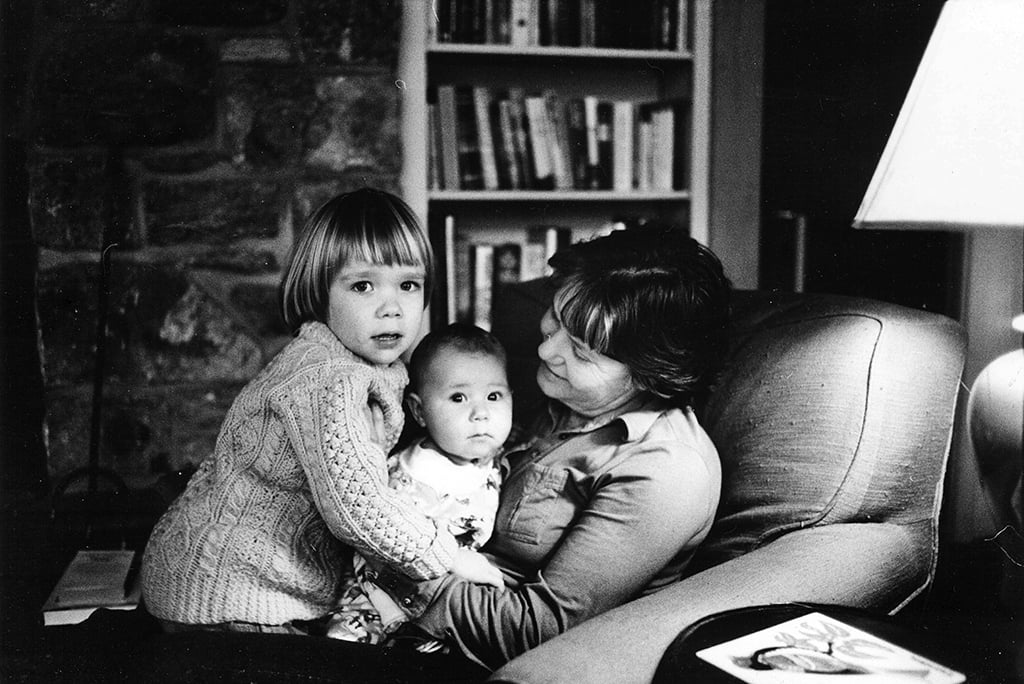 Martha Wainwright is a toddler and her brother Rufus is a baby in this black and white photo. They are in their grandmother Martha’s lap, visiting her home in New York. The children are looking at the camera with serious expressions. Their grandmother is smiling at the baby.  