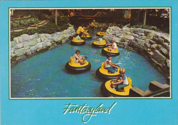 Children ride round yellow vessels that float in the water at the Fantasyland hotel. The vessels include a small yellow seat and a steering wheel.