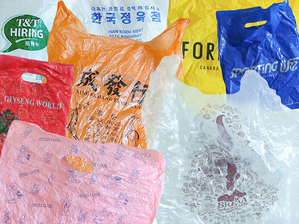 A collection of colourful plastic bags are layered over each other. The bags are orange, yellow, blue, white, pink and red.