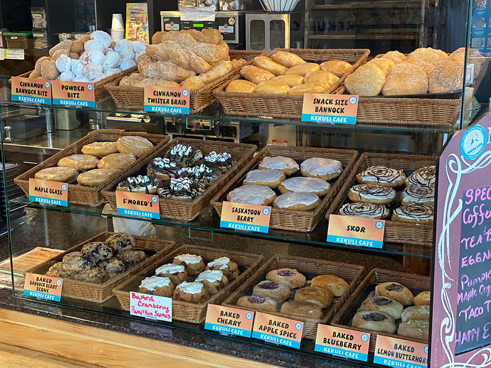 A glass display case at a Kekuli Cafe location showcases different kinds of bannock, including S’moreos, Saskatoon berry, and maple glaze.