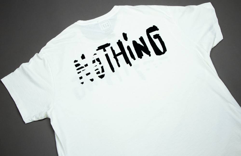 The top image features a black pair of winter mittens with a sprocketed hole carved out of where the top of the index and middle fingers would be for a smoker to hold a cigarette. The bottom image features a white T-shirt with the word “Nothing” on it in black and white typeface.
