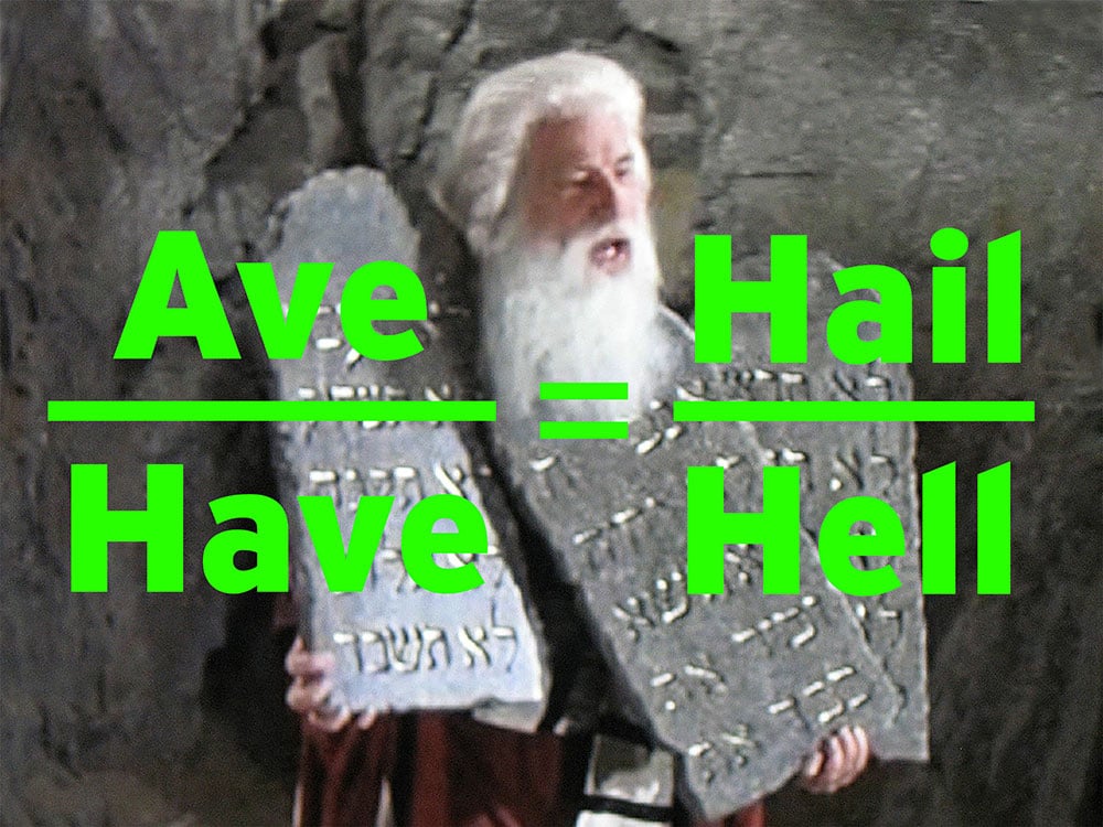 Mel Brooks plays Moses in a white beard and white hair. He is holding a collection of cartoonish ancient silver tablets in both hands. Across the screen in sans-serif bright green text, “Ave” over the word “Have” on the left, “Hail” over the word “Hell” on the right.