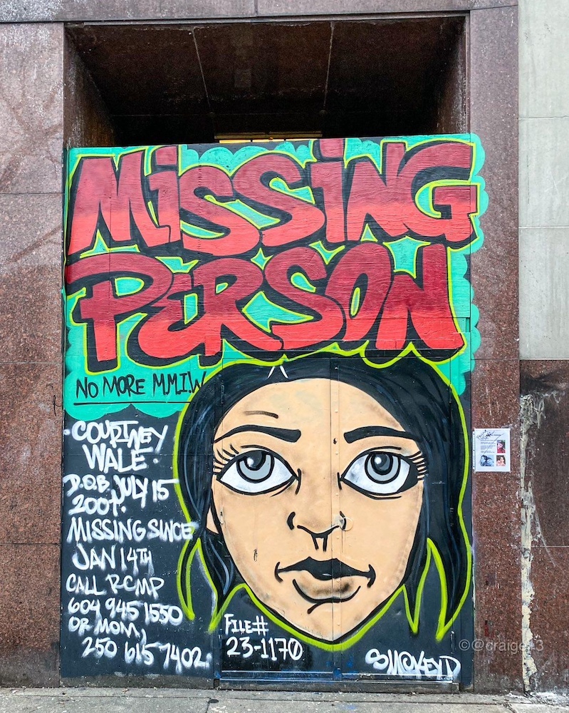 A mural reads “Missing person” in bold red text with an illustration of Courtney Wale, an Indigenous woman with short dark hair and grey eyes. Alongside the illustration are details about how long she has been missing and who to call if anyone sees her.