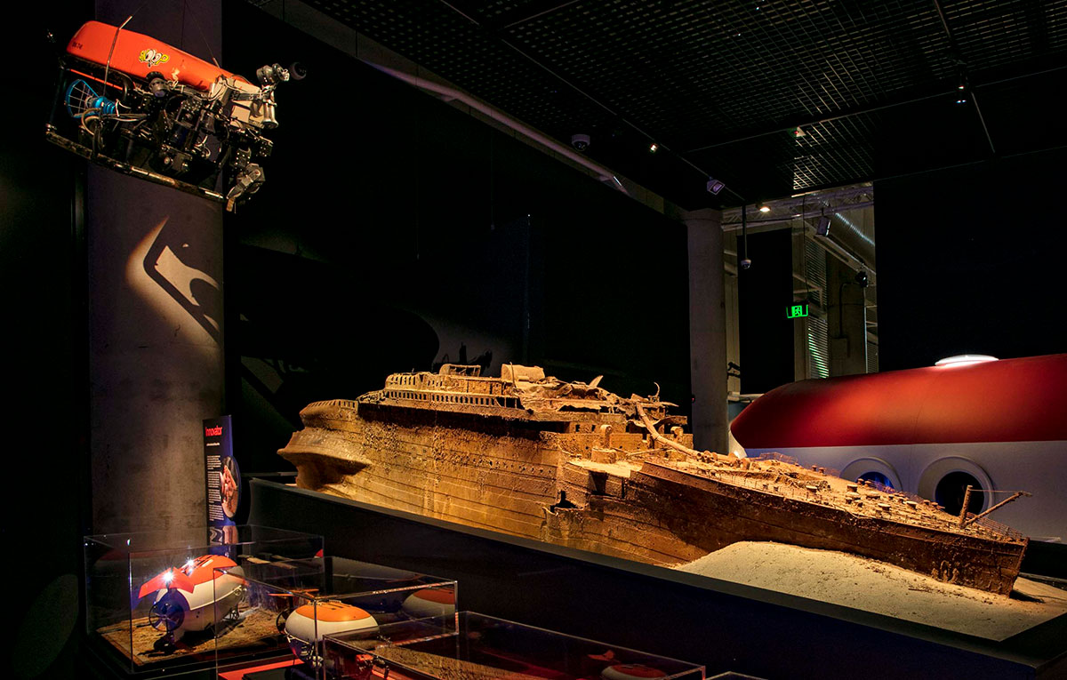 A mock-up of the bow section of the Titanic wreck sits poised among the diagrams and submersibles used to visit her at the deep ocean depths.