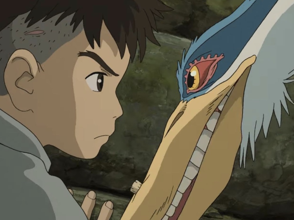 An anime still of a young boy, left, staring grimly at a heron, right. The tones are grey and blue, and both are against a dark grey illustrated background.