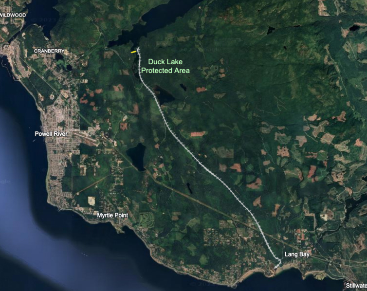 A silver railway drawn onto a Google Earth map runs north-south. The yellow bar, which is close to the railway but does not overlap it, runs east-west.