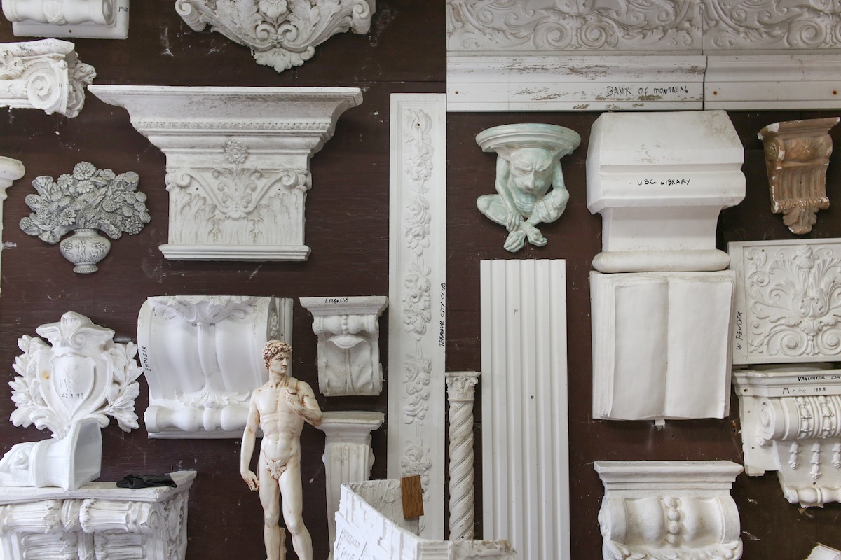 A variety of white mouldings mounted to a brown wall.