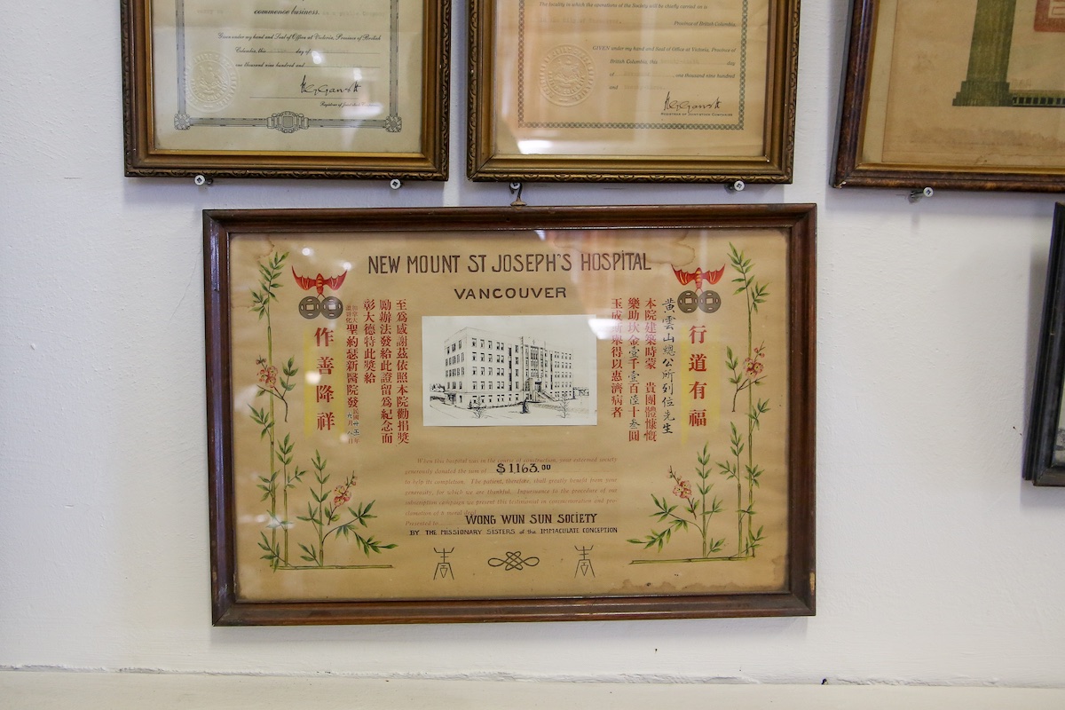 A framed beige certificate with green bamboo brushwood declares the receipt for the establishment of Mount Saint Joseph Hospital in Vancouver.