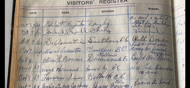 A close-up image of a book that says 'Visitors’ Register' and has entries including dates, names and addresses, all dated 1969.