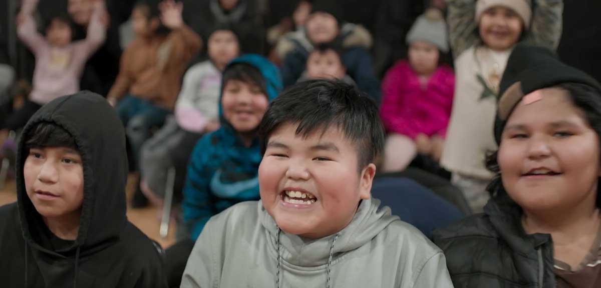 A closeup of a grinning elementary school child.