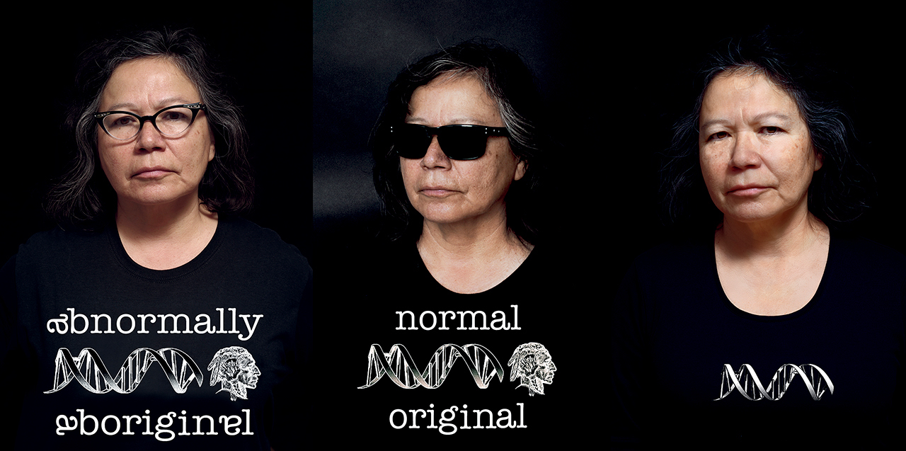 A three-panel image depicts three photographs of the same Indigenous woman in a black T-shirt whose white logo and script changes across the panels from reading 'abnormally Aboriginal' to 'normal original' to, in the last image on the right, a lone silver helix. The woman has dark greying shoulder-length hair and is photographed wearing glasses on the left, sunglasses in the middle, and no glasses on the right.