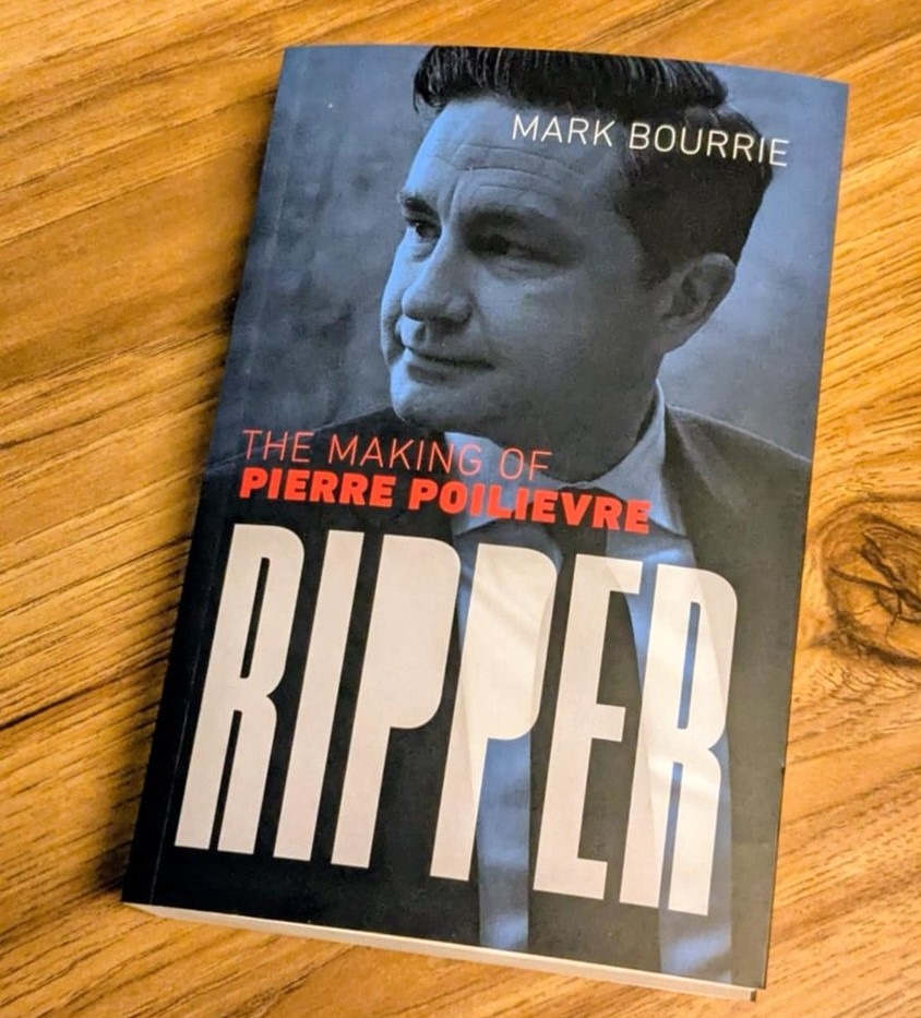 A copy of the book ‘Ripper: The Making of Pierre Poilievre’ sits on a wooden table.