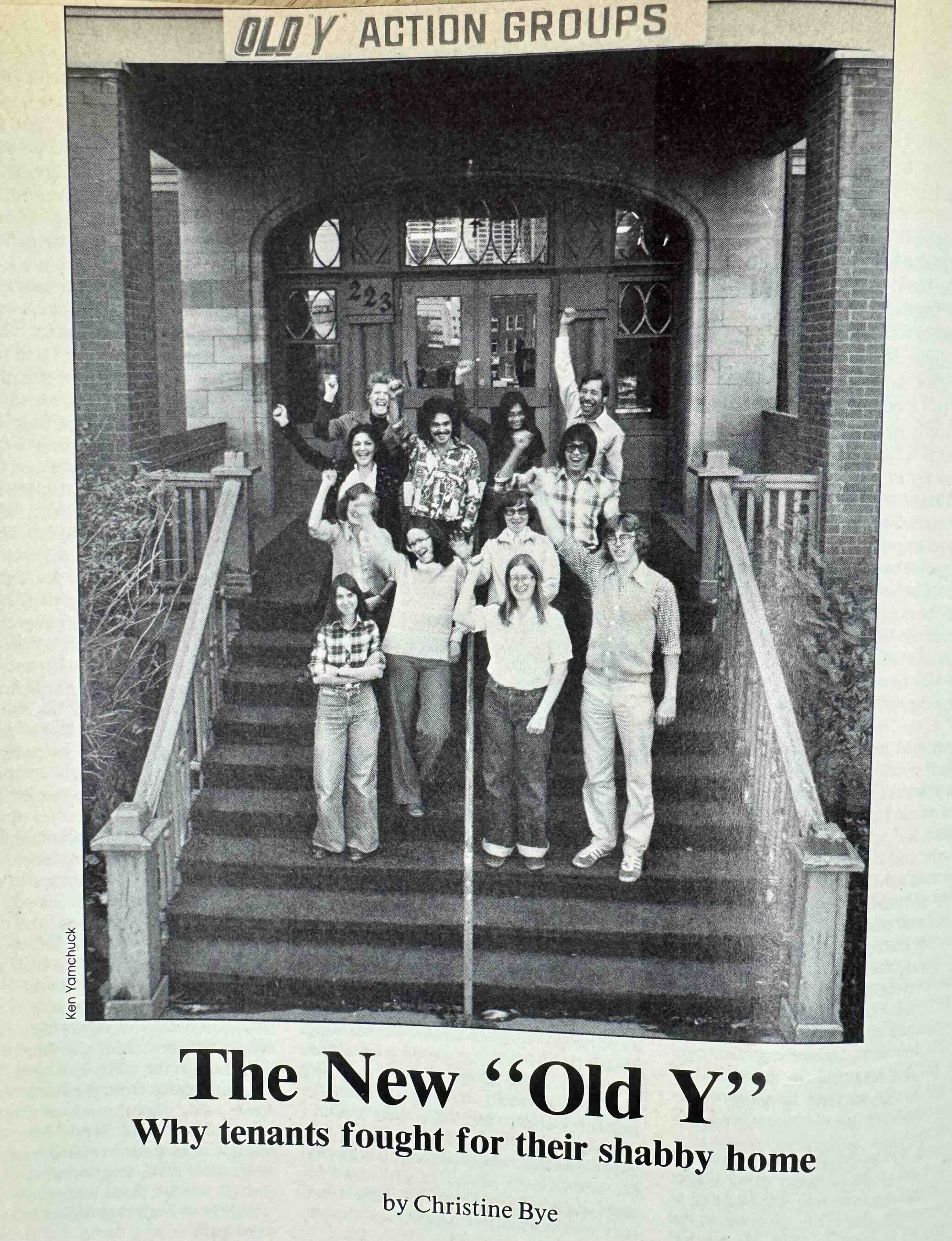 A black-and-white magazine clipping features a photograph of a group of people standing on a flight of stairs outside a historic building with their fists up in solidarity, smiling. They are standing below a sign that reads “Old Y Action Groups.” A headline at the bottom of the page reads “The New ‘Old Y:’ Why tenants fought for their shabby home.”
