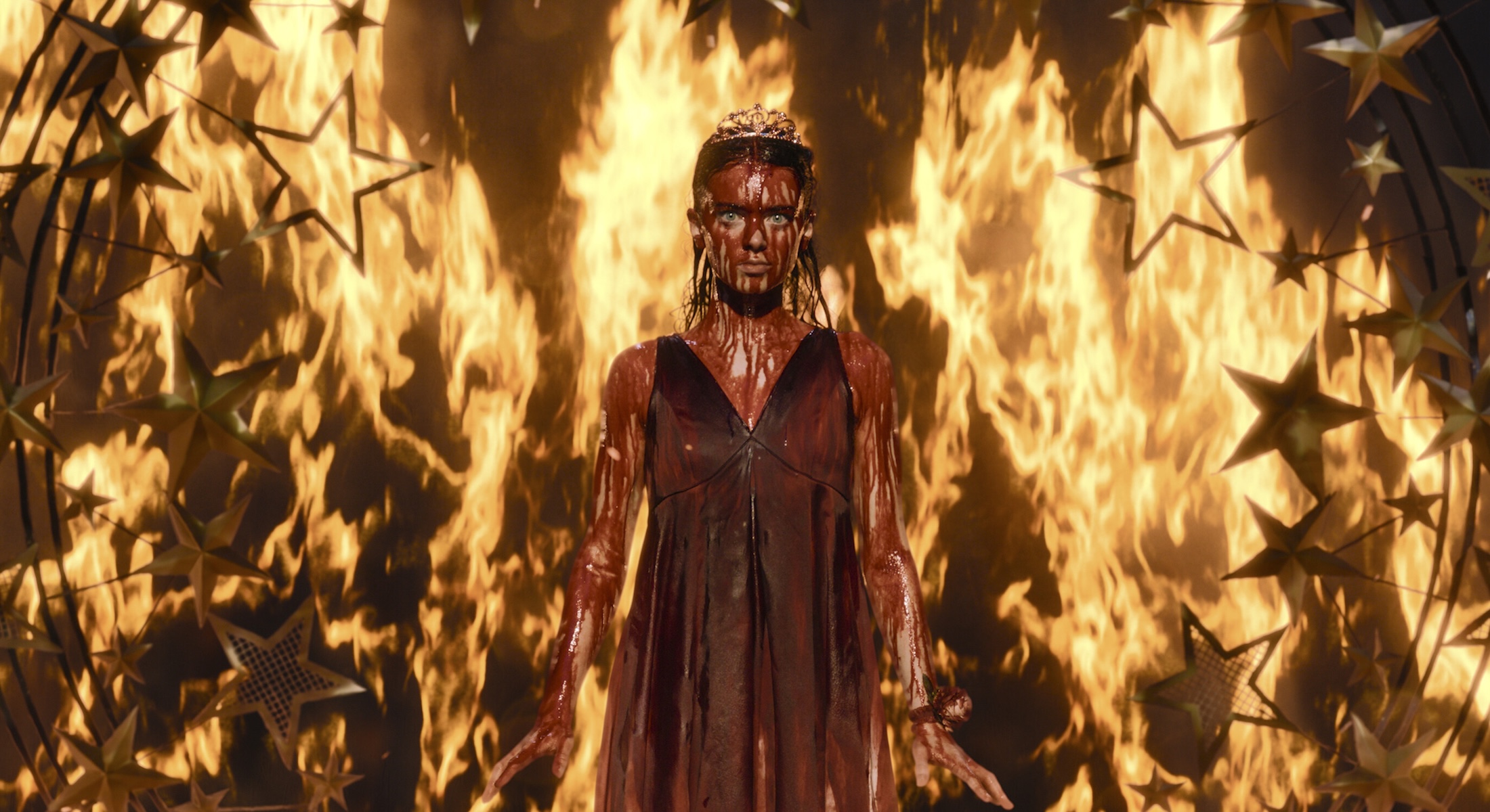 A video still features the actor Summer H. Howell covered in bold against a backdrop of flames.