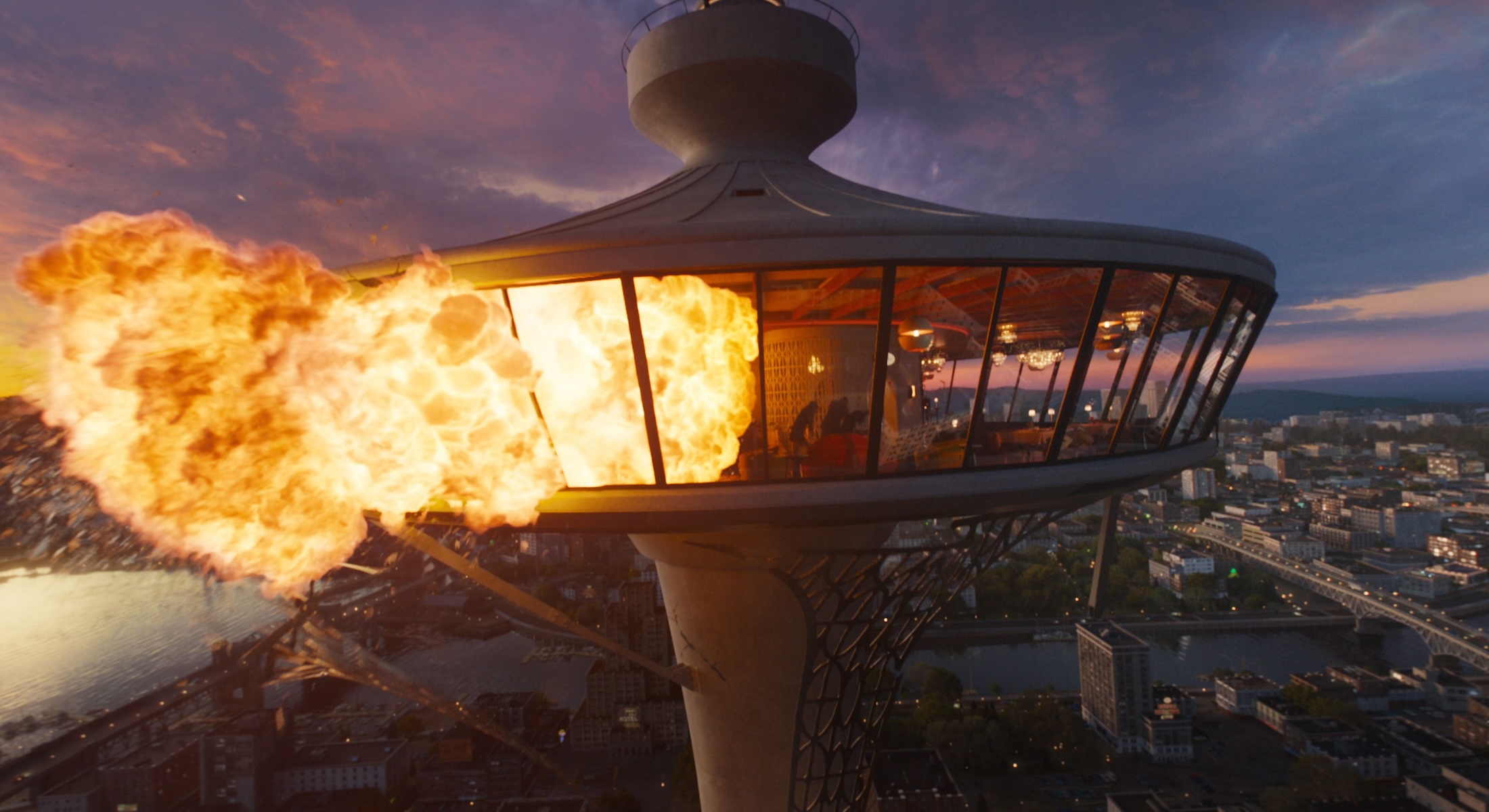 A film still features a computer-generated image of the left side of a revolving restaurant in flames. The restaurant sits atop a cityscape resembling Vancouver&rsquo;s False Creek at sunset.