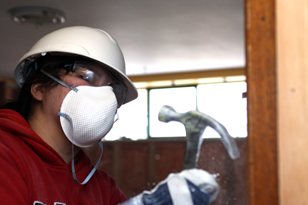 582px version of Worker deconstructing drywall