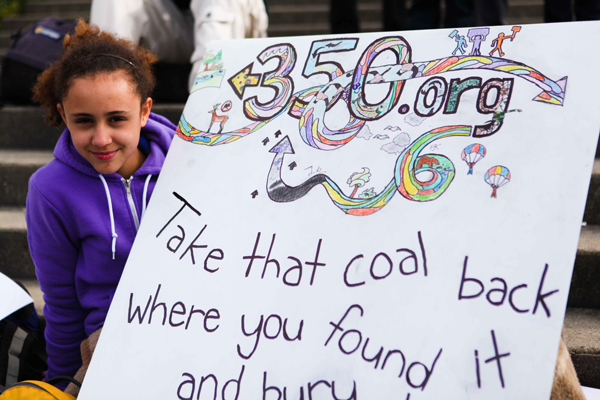 582px version of Child posing with 350.org sign