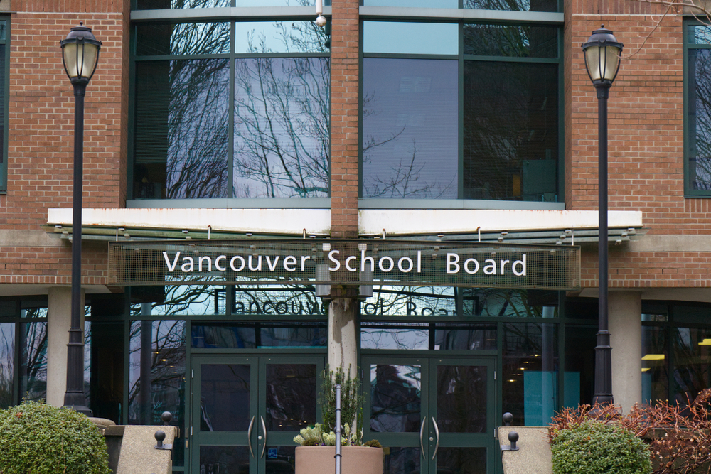  A red brick building with “Vancouver School Board” above the doors.