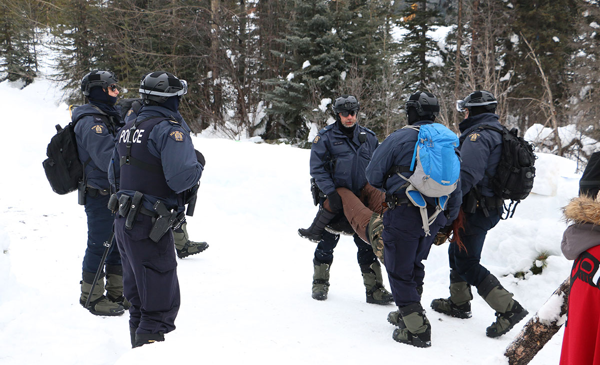 Police carrying away a protester.