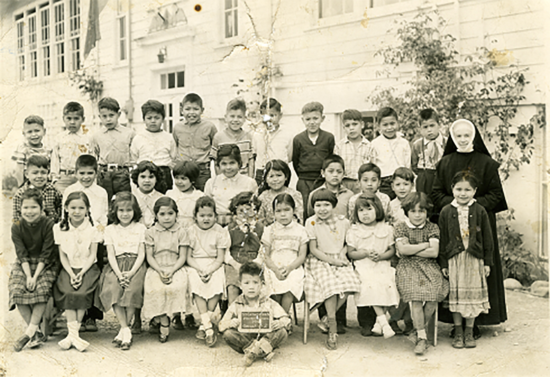 An old, black-and-white photo of a Grade 2 class at St. Catherine's school with Glenda Gill.
