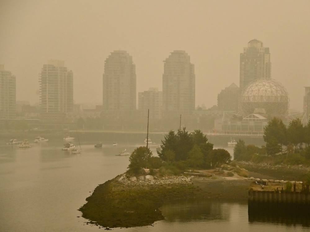 A pall of brown haze hangs over Vancouver’s False Creek.