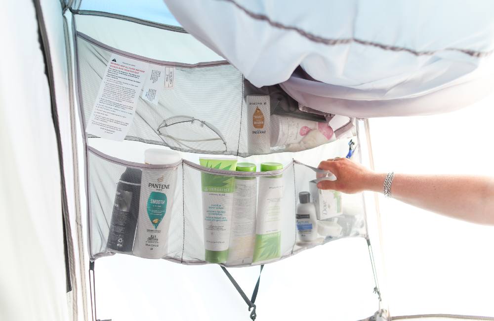 The inside of a tent with about a dozen hair products.
