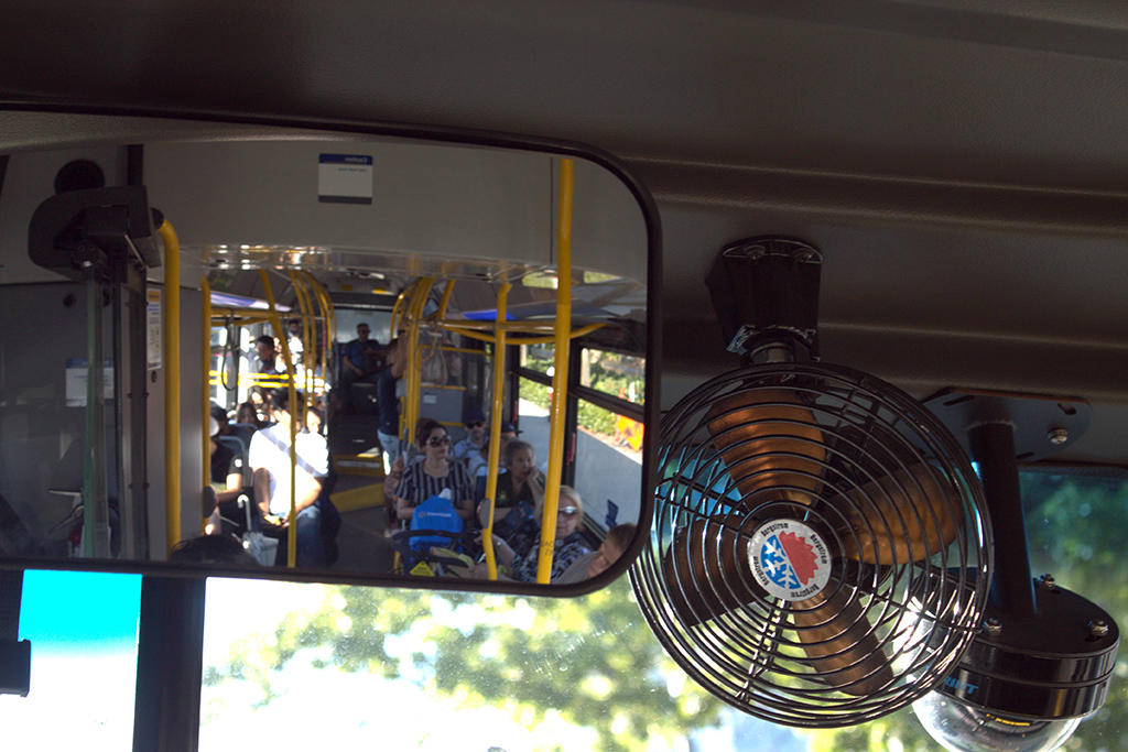 The view from the rear window of the 255 bus that runs across the North Shore. One can see yellow fixtures, blue seats and a relatively light load of passengers because it’s not rush hour. Even now, the bus is 20 minutes behind because the route is so challenging.