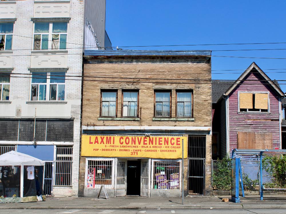 East Hastings Street in mid-day. Pictured are three buildings, one of them the site of Laxmi Convenience store, where Amyotte was shot by police. 