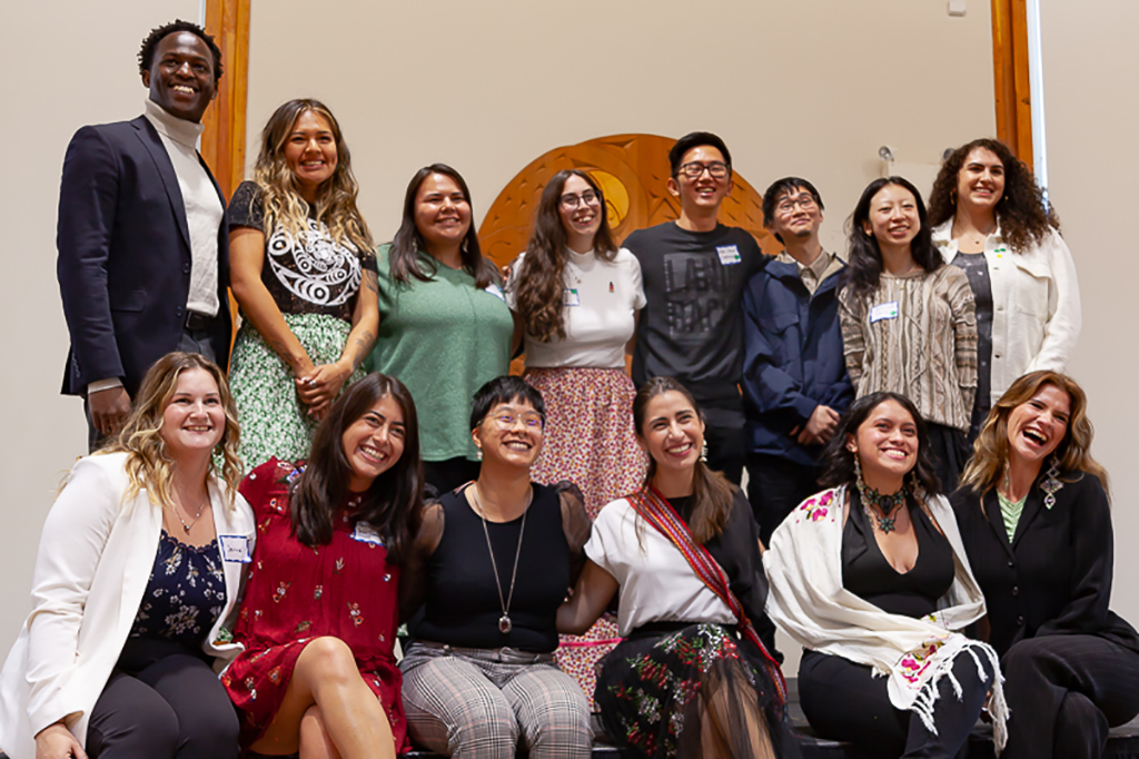 Fourteen people pose for a group photo.