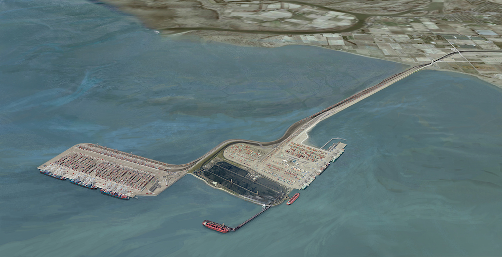 An aerial rendering shows a port addition. The original port is attached to the mainland via a skinny road. The water surrounding the port appears fairly shallow and muddy.