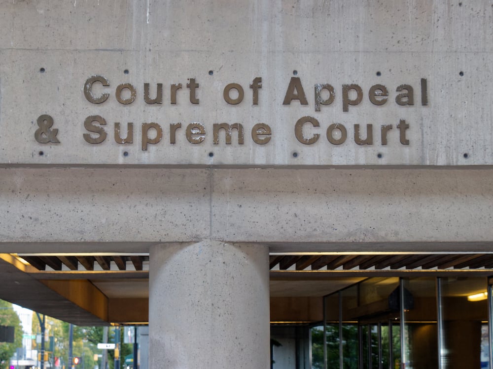 The concrete side of a building with the words ‘Court of Appeal and Supreme Court’ on it.