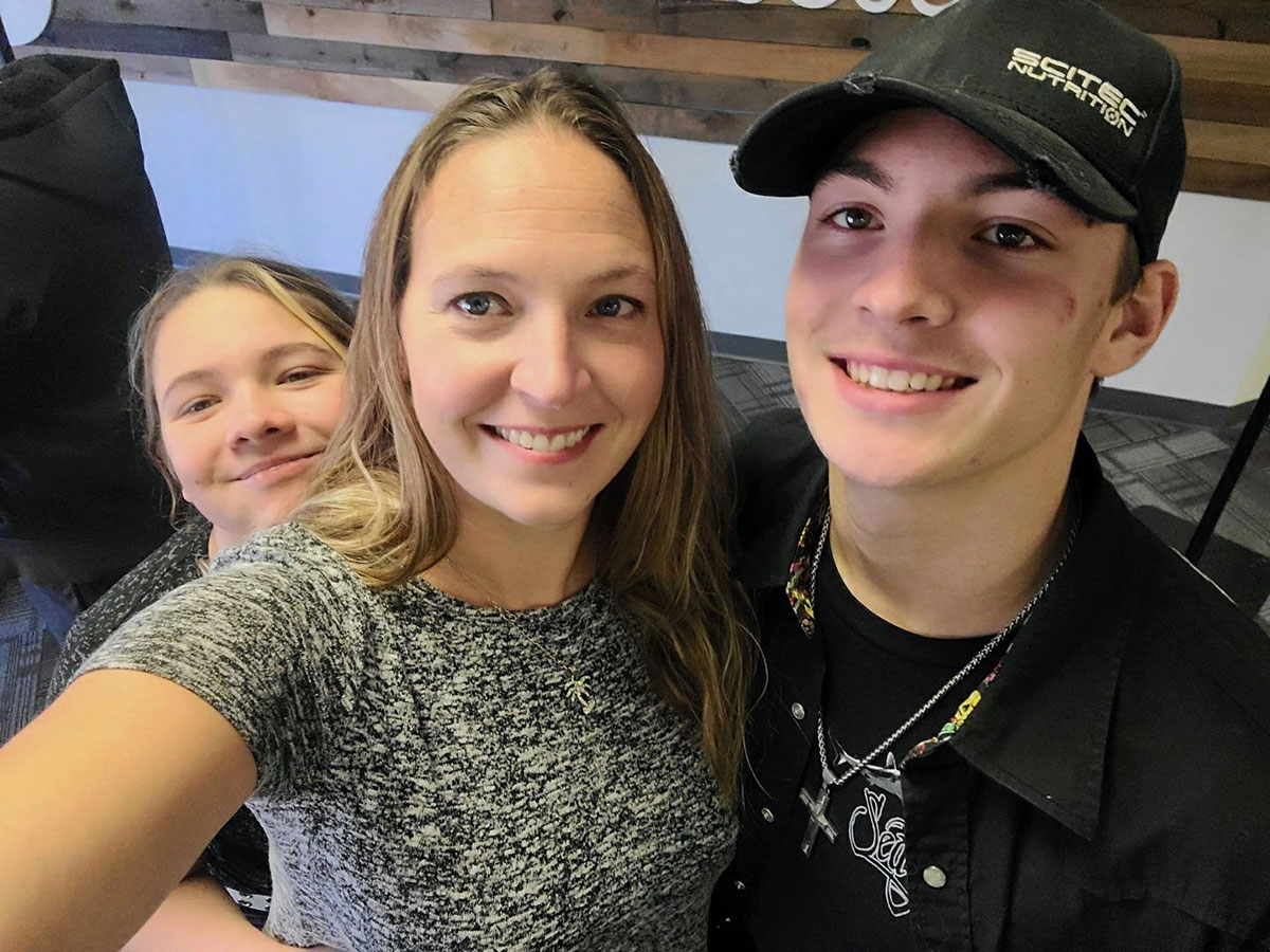 Rhonda Simpkins, with the couple’s two children, smiles at the camera.