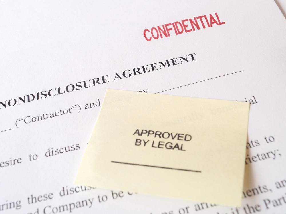 A contract shows the words “Non-Disclosure Agreement,” “Confidential” and “Approved by legal.”
