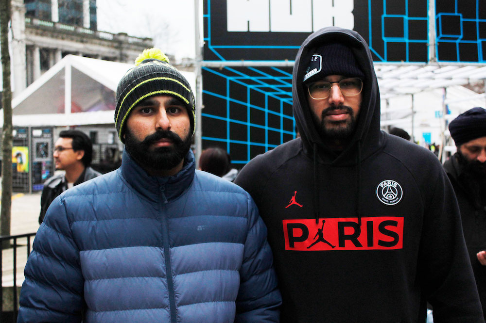 Two people wearing winter clothes look at the camera.