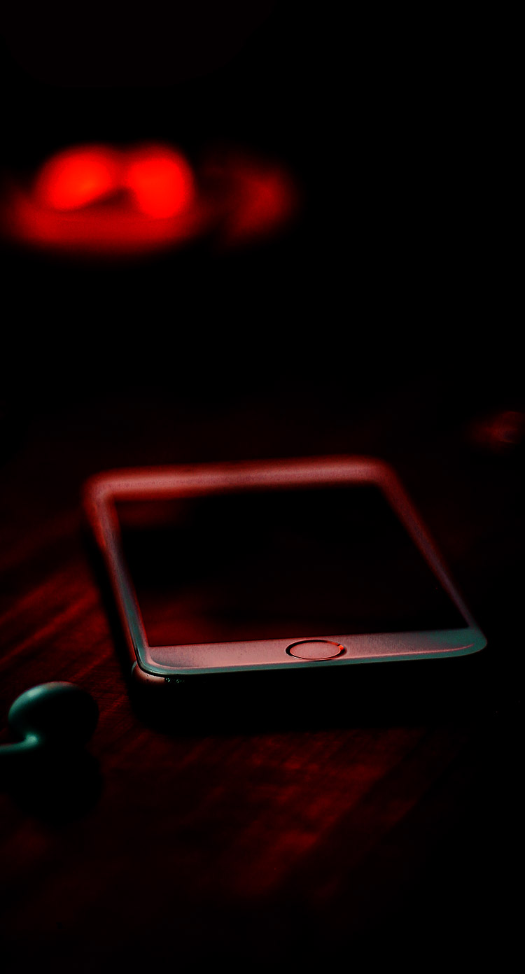 A phone on a table in a dark room